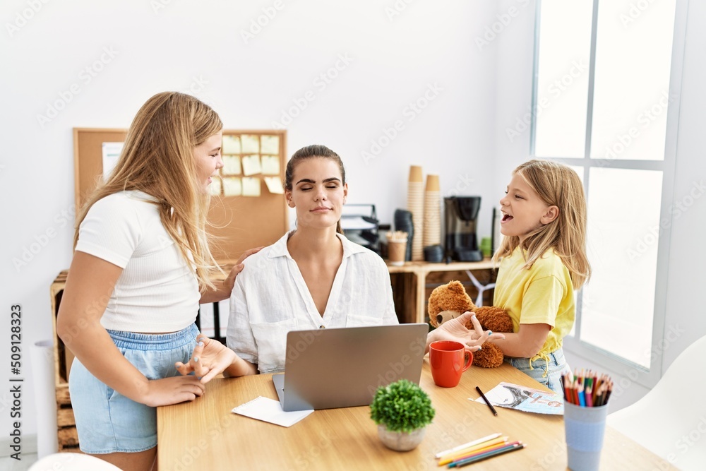Mother and daughters business worker doing yoga exercise while girls scream at office Mother and daughters business worker doing yoga exercise while girls scream at office