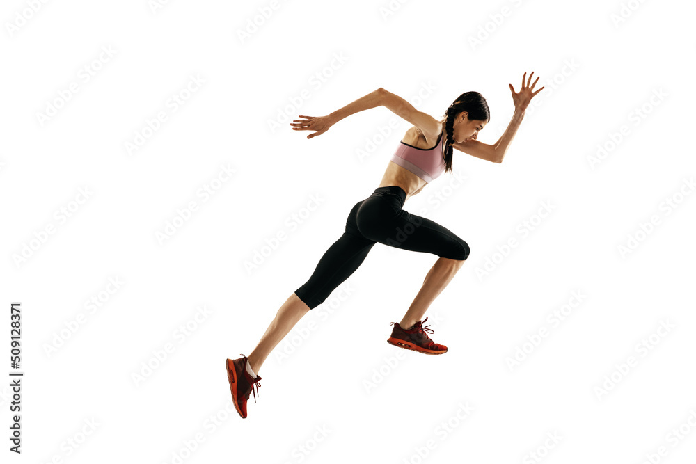 Young caucasian woman running isolated on white studio background. One female runner or jogger. Sport, track-and-field athletics, competition concept