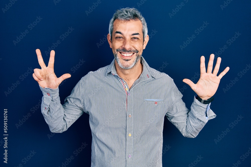 Naklejka premium Handsome middle age man with grey hair wearing business shirt showing and pointing up with fingers number eight while smiling confident and happy.