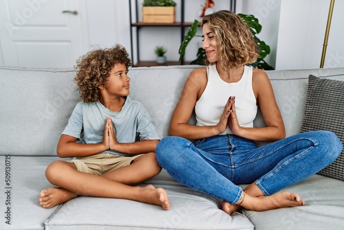 Mother and son meditating doig yoga exercise at home
