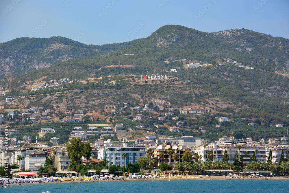 Alanya town with waterfront and mountains on background