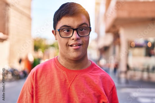 Down syndrome man smiling confident standing at street
