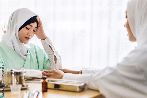 Muslim asian woman doctor service help support discussing and consulting talk to muslim woman patient at meeting health medical care express trust concept in hospital.healthcare and medicine
