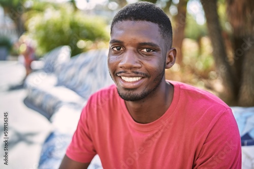 Young african man smiling confident at park © Krakenimages.com