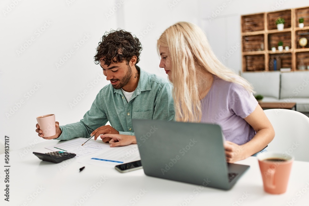 Young couple controlling family economy at home. Young couple controlling family economy at home.