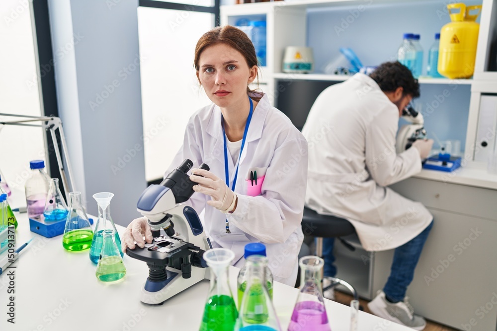 Young two people working at scientist laboratory thinking attitude and sober expression looking self confident Young two people working at scientist laboratory thinking attitude and sober expression looking self confident