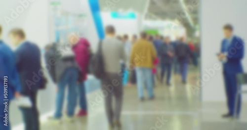 modern business life. defocused blurry video. background on the theme of business. blurred silhouettes of unrecognizable people walking in a large hall. photo