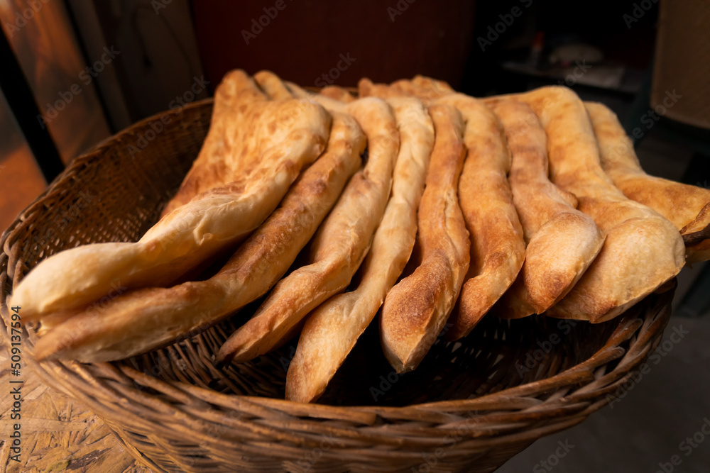Stack of delicious traditional Georgian Shoti bread in a wicker basket