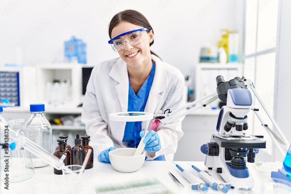 Young hispanic woman wearing scientist uniform working at laboratory Young hispanic woman wearing scientist uniform working at laboratory