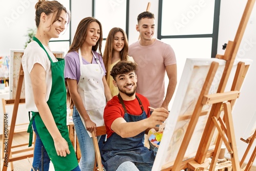 Group of people smiling happy and looking draw of partner at art studio.