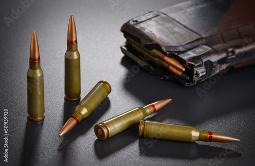 Ammunition for a automatic rifle on black surface with a magazine