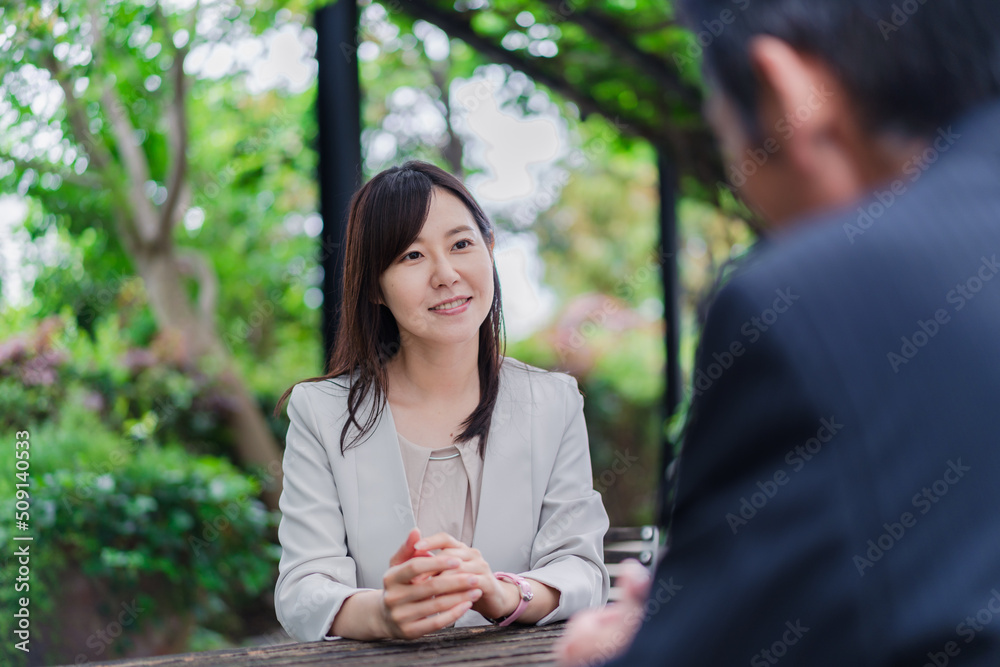 屋外で意見交換をするビジネスウーマン