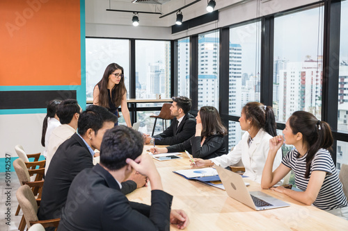 Caucasian team leader and multiethnic business colleagues meeting with seriously about the future business plan of modern office