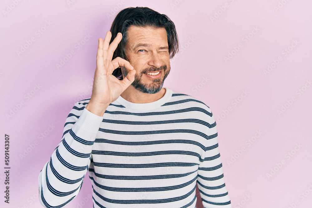 Middle age caucasian man wearing casual clothes smiling positive doing ok sign with hand and fingers. successful expression. Middle age caucasian man wearing casual clothes smiling positive doing ok sign with hand and fingers. successful expression.