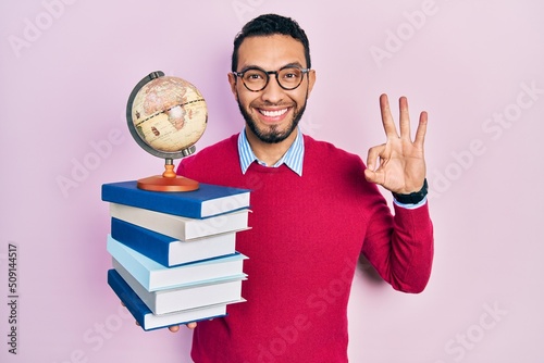 Fotografia Hispanic man with beard geography teacher doing ok sign with fingers, smiling fr