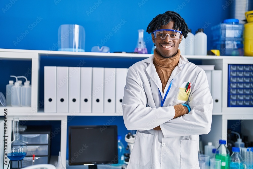 African american man scientist standing with arms crossed gesture at laboratory