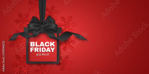 Realistic label of paper box with 3d bow for Black Friday sale. Advertising tag for your business promotions. Decoration of red paper snowflakes. Commercial discount event. Vector illustration