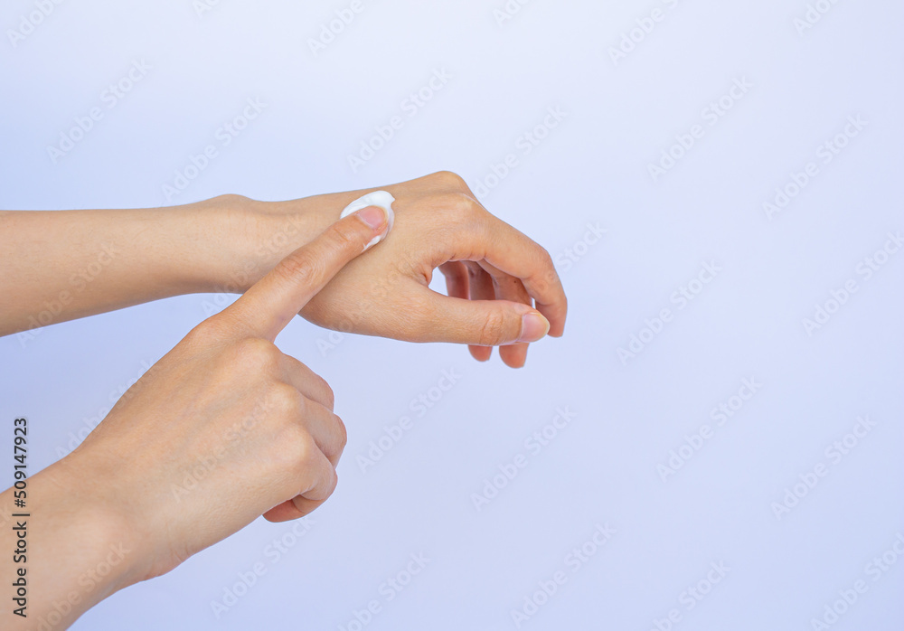 Woman applying moisturizing cream on her hand. Skin care concept. Woman applying moisturizing cream on her hand. Skin care concept.