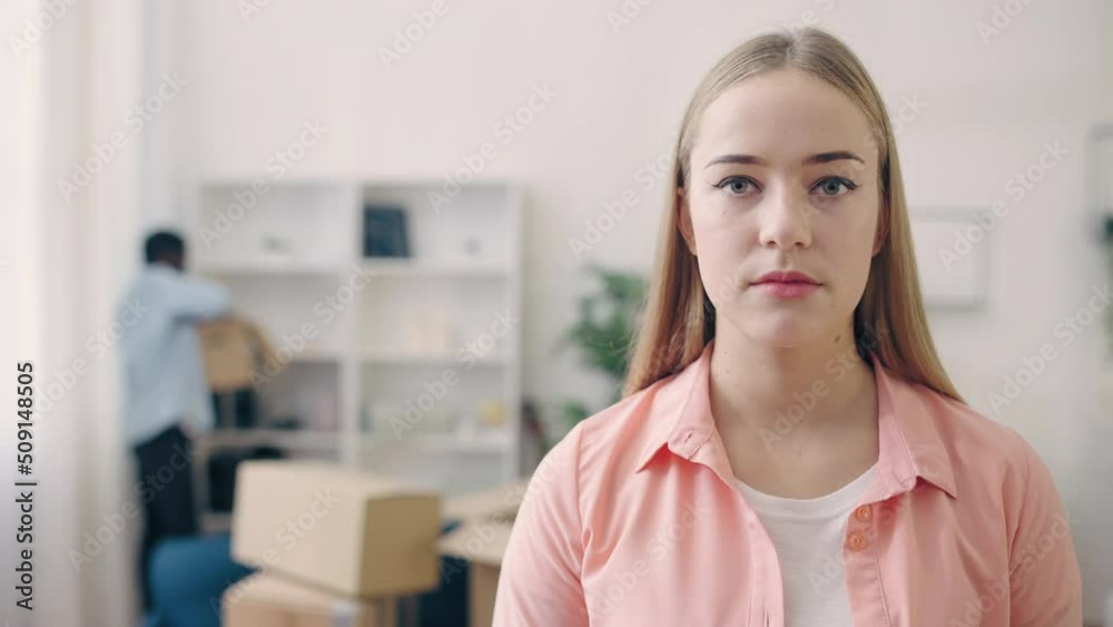 Young woman feeling sad about break-up, partner moving out of apartment, packing Young woman feeling sad about break-up, partner moving out of apartment, packing
