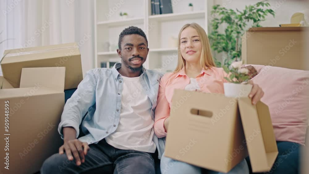 Portrait of happy multiethnic couple in a new apartment together, home rental Portrait of happy multiethnic couple in a new apartment together, home rental