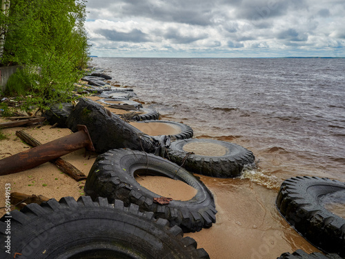 view of the sandy beach by the Baltic Sea. Seashore with old car tires and concrete, human waste, Curonian Spit, 