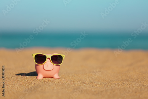 Piggybank on the beach in summer