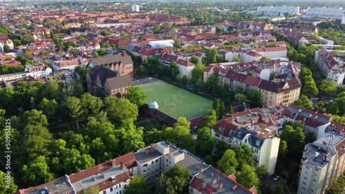 Green soccer field in the middle of the capital of Germany 
Wonderful aerial view flight rising up drone footage
of Berlin Friedenau Summer 2022. Cinematic view above Tourist Guide by Philipp Marnitz photo