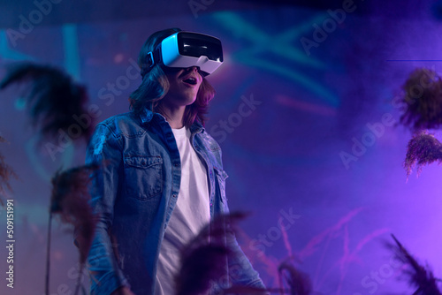 Metaverse digital cyber world technology, man with virtual reality VR goggles playing augmented reality game, futuristic lifestyle