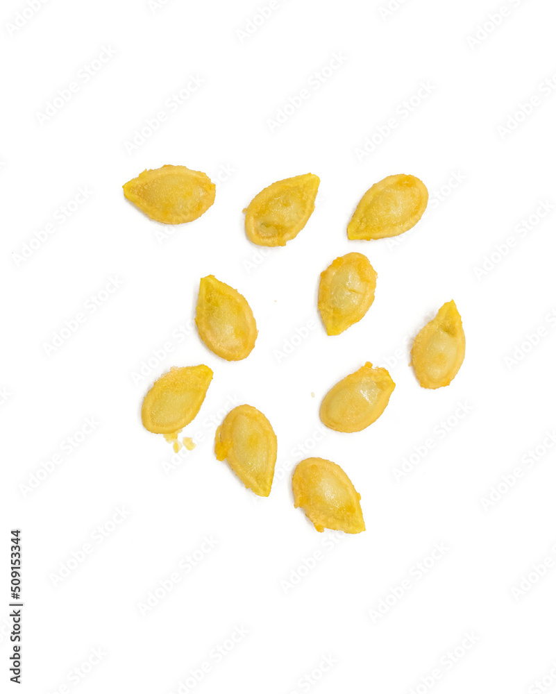 Pumpkin seeds over on white background. Selective focus. Pumpkin seeds over on white background. Selective focus.