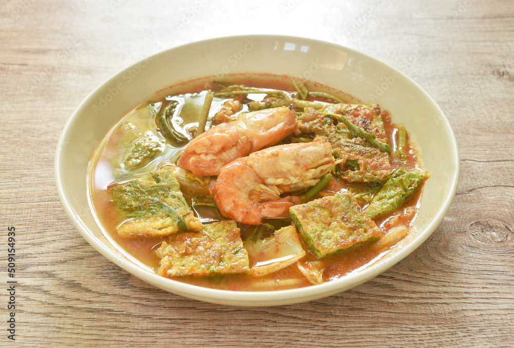 boiled shrimp and fried egg stuffed climbing wattle vegetable in spicy sour soup on plate boiled shrimp and fried egg stuffed climbing wattle vegetable in spicy sour soup on plate