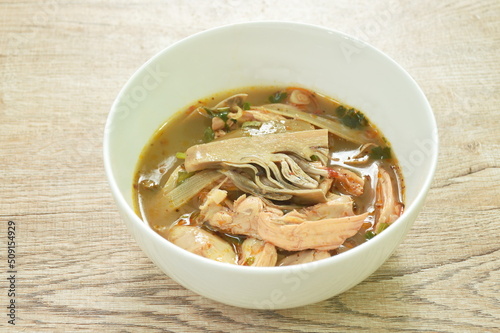 spicy boiled chicken meat with ripe banana blossom soup on bowl