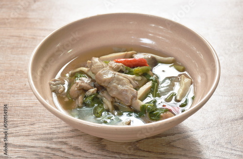 spicy boiled mixed mushroom and basil leaf soup on bowl 