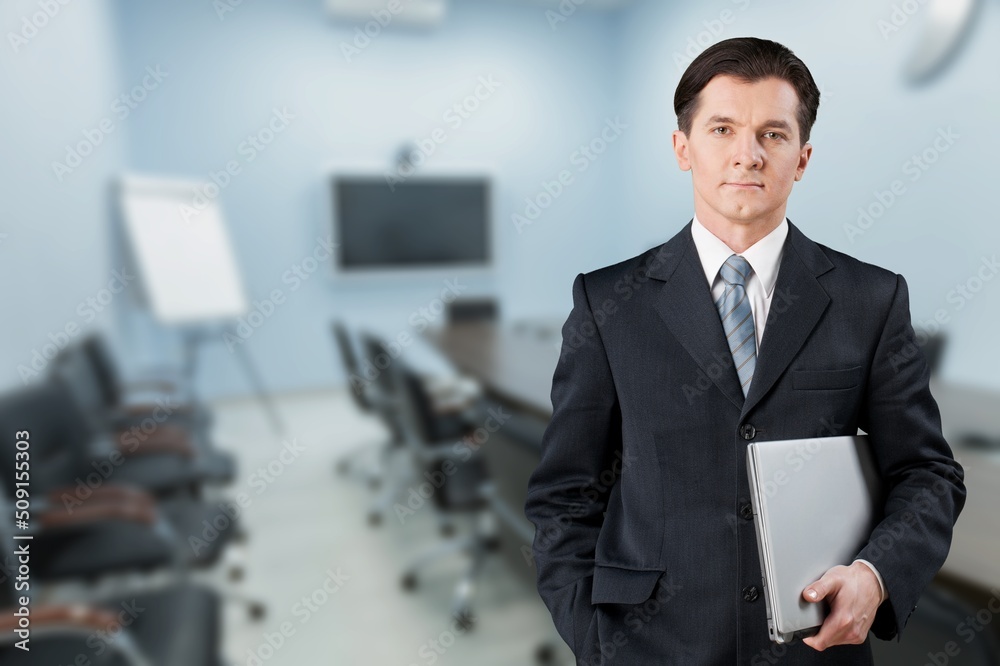 Overjoyed excited man holding laptop while looking at camera