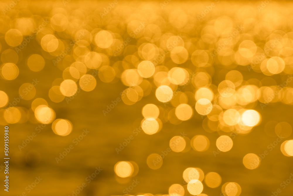 Bokeh light from reflection of golden water surface in the evening sunset Bokeh light from reflection of golden water surface in the evening sunset