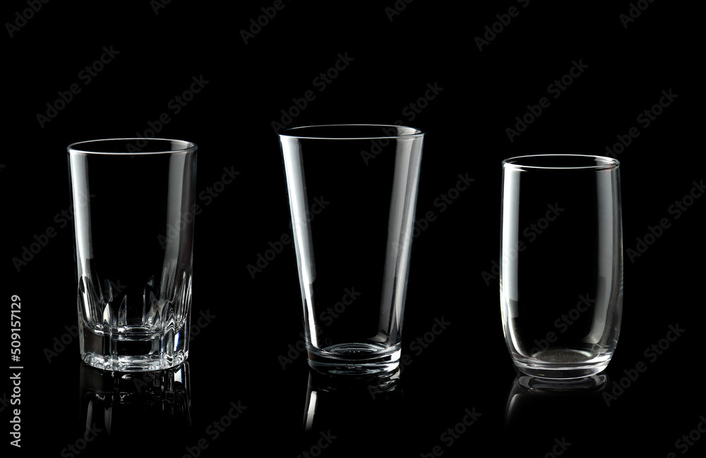 Set of empty glass of water isolated on black background Set of empty glass of water isolated on black background