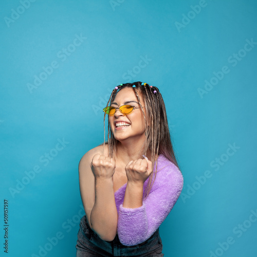 Young woman laughing. Happy gesturing smiling youngfemale model on blue