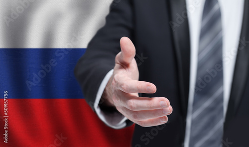 Russian business, politics, cooperation and travel concept. Hand on flag of Russia background.