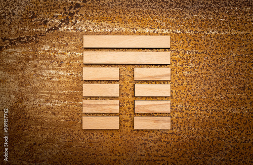 wooden Gene Key 20 i ging hexagram on rusty metal background human design photo