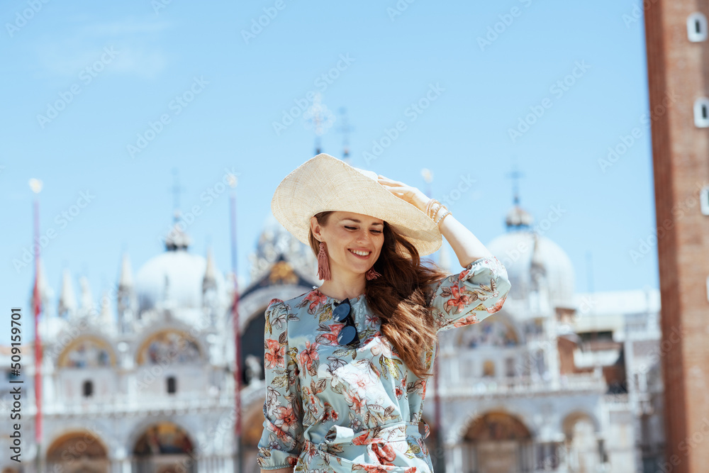 happy elegant tourist woman in floral dress having excursion