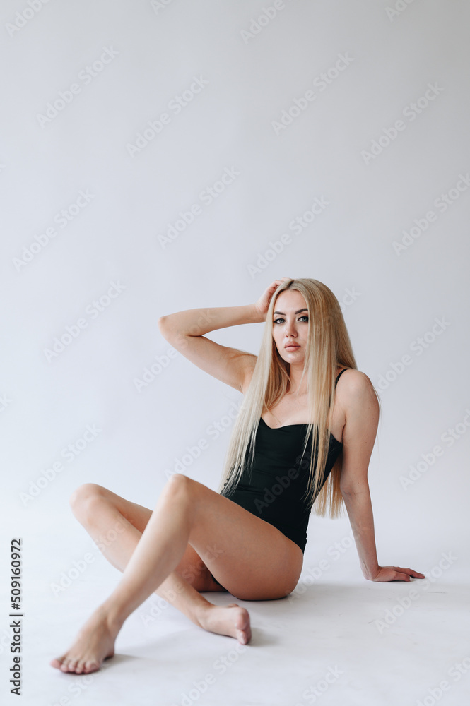 Depilation advertisement. A girl in a swimsuit with long legs in the foreground. Depilation advertisement. A girl in a swimsuit with long legs in the foreground.