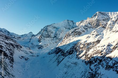 snow covered mountains in winter and glacier valley in the Swiss Alps © Bergimus communicati