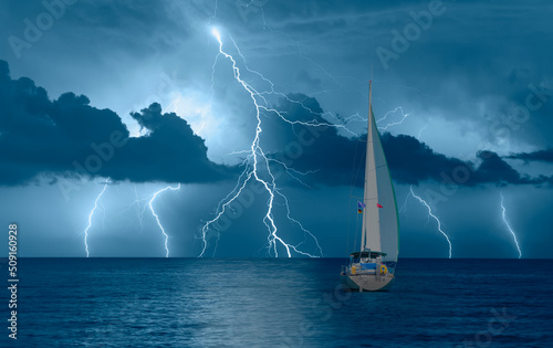 Sailing yacht in a stormy weather with thunder and lightning