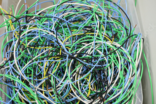Tangled, disorganized and several strands of light, with different colors, in a plastic box.