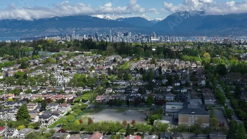 Dreamy Cloudscape Over The Vast Neighborhood And Mountain Scenery Of Oakridge Overlooking The City Of Vancouver In The Background, Canada. Aerial Pullback