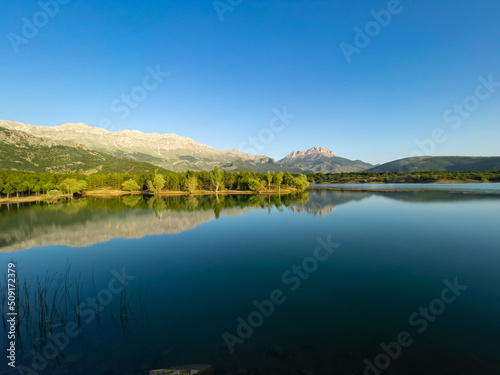 Morning reflections, mystical nature and fascinating mountains in the dam pond