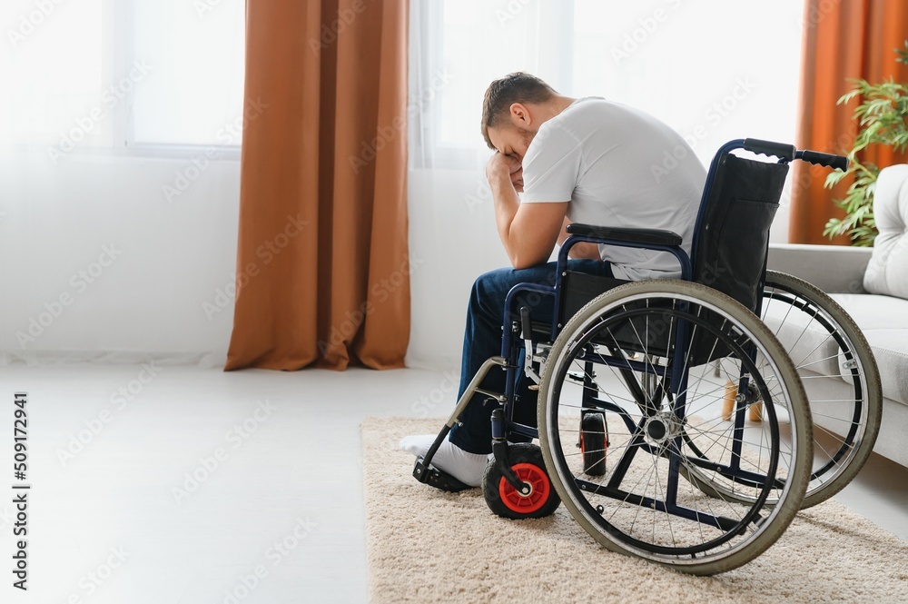 Depression and loneliness in disabled man. Elderly man in wheelchair crying indoors. Depression and loneliness in disabled man. Elderly man in wheelchair crying indoors.