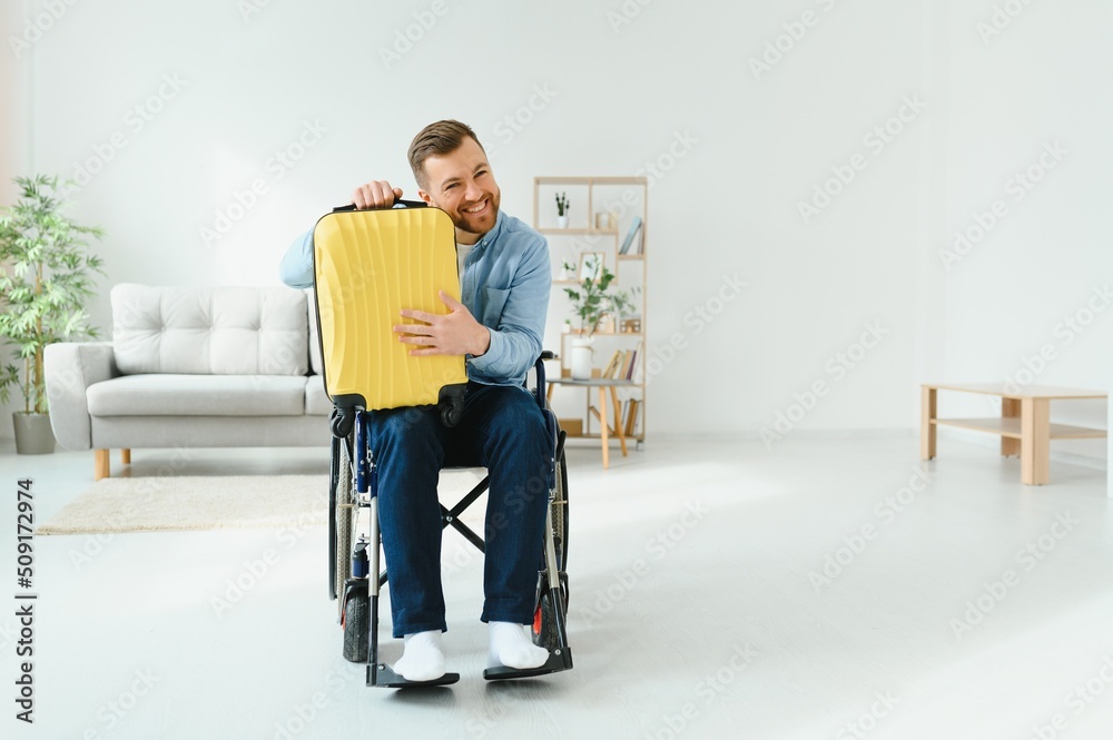 A person with disabilities at home with a suitcase is preparing for vacation. Leisure concept. A person with disabilities at home with a suitcase is preparing for vacation. Leisure concept.