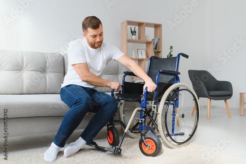 Disabled young black guy trying sit down