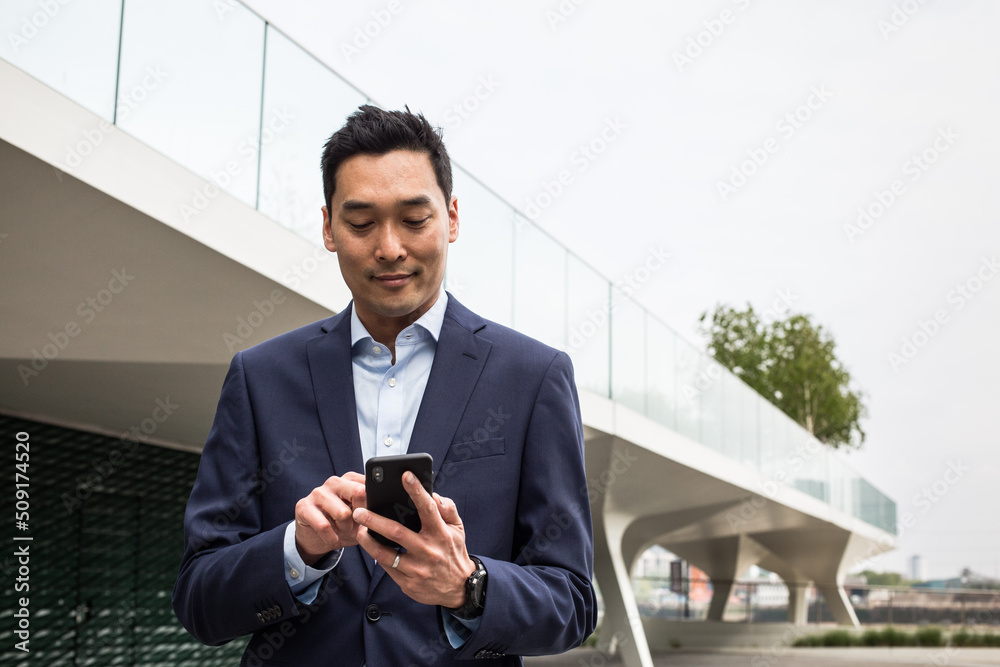 Businessman on his daily commute using smartphone Businessman on his daily commute using smartphone