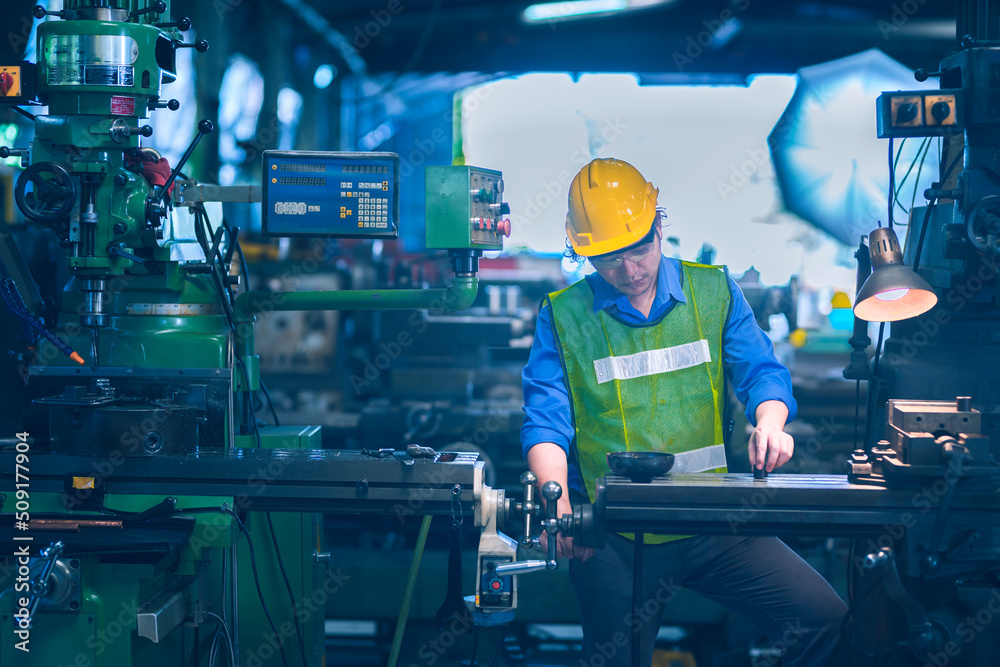 the working yellow safety helmet working with machinery in industrial the working yellow safety helmet working with machinery in industrial